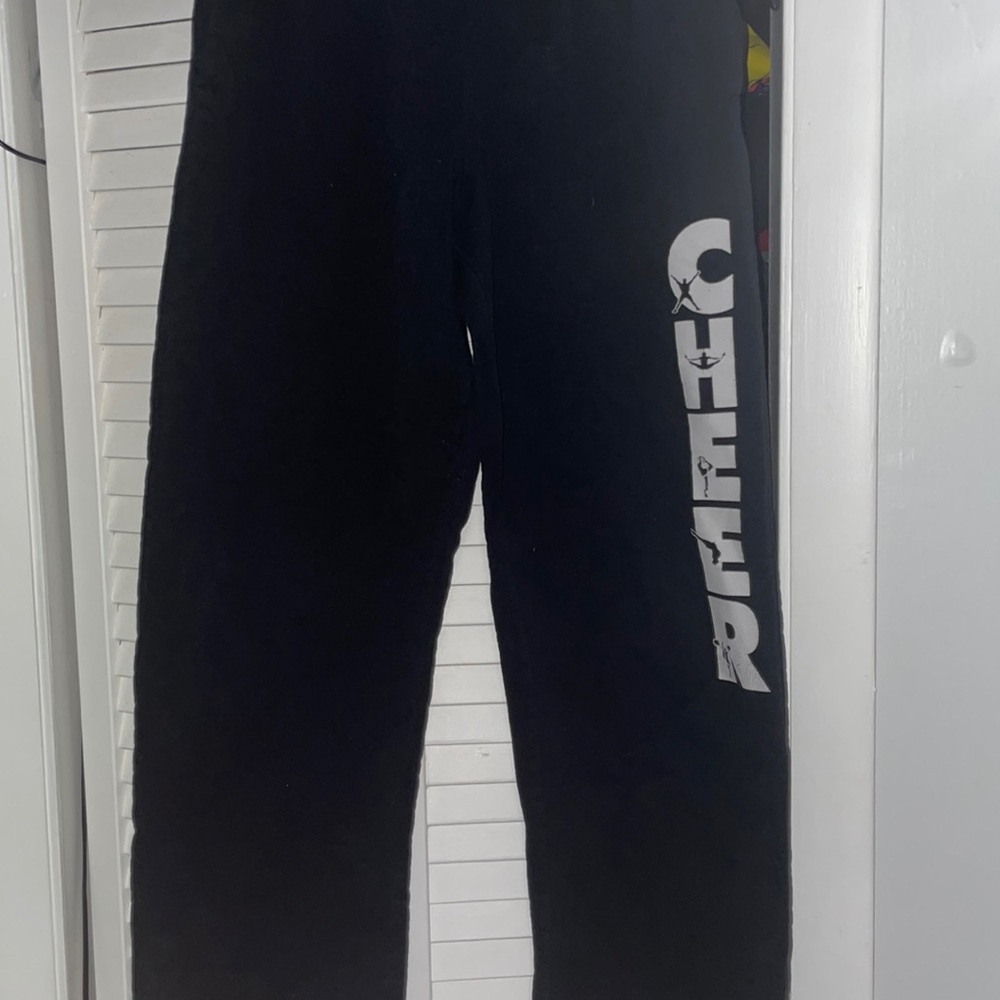 Medium Sized, black sweatpants with “CHEER” down the leg.